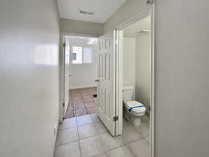 Hallway featuring light tile patterned flooring