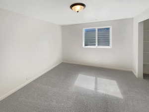 Carpeted spare room featuring a textured ceiling