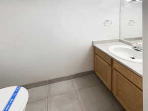 Bathroom with vanity, toilet, and tile patterned floors