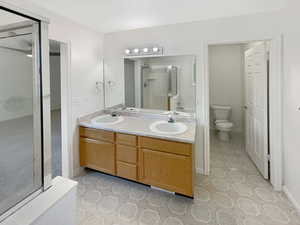 Bathroom with walk in shower, vanity, and toilet