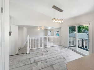 Interior space with a notable chandelier and lofted ceiling