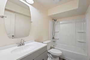 Full bathroom featuring vanity, bathing tub / shower combination, and toilet