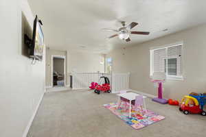 Game room with carpet floors, a textured ceiling, and ceiling fan