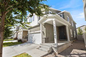 View of front of property with a garage and a porch