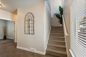 Staircase with hardwood / wood-style flooring