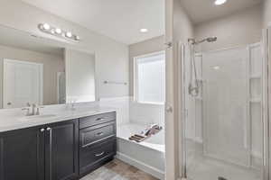 Bathroom with vanity and separate shower and tub