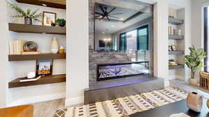 Living room featuring light wood-type flooring and a fireplace