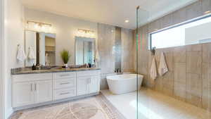 Bathroom with vanity, plus walk in shower, and tile patterned floors