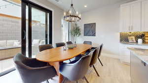 Dining space featuring a chandelier and light hardwood / wood-style floors