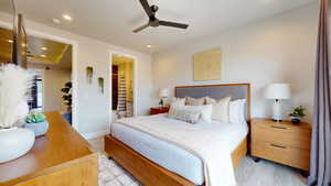 Bedroom featuring light hardwood / wood-style floors, ensuite bath, and ceiling fan