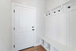 Mudroom with hardwood / wood-style flooring