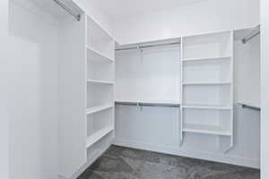 Spacious closet featuring dark carpet