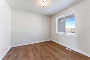 Spare room featuring hardwood / wood-style flooring