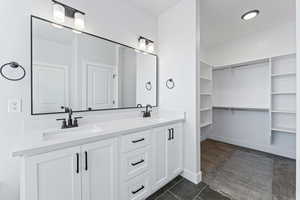 Bathroom with tile patterned floors and vanity