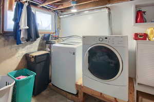 Washroom featuring washing machine and clothes dryer