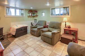 Living room with a baseboard radiator and plenty of natural light