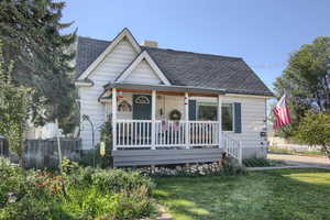 Bungalow with a front yard and a porch