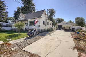 Bungalow featuring a front lawn and a two car garage