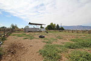 View of yard with a rural view and a mountain view