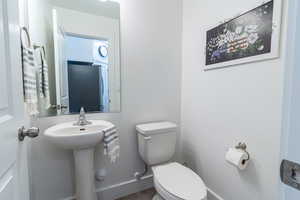 Bathroom with hardwood / wood-style floors and toilet