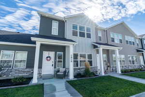 View of front of home featuring a front yard and a porch