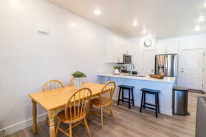 Dining room with light hardwood / wood-style flooring and sink