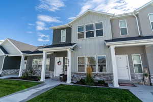 View of front of house featuring a front lawn and covered porch