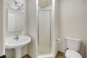 Bathroom with a shower with shower door and toilet