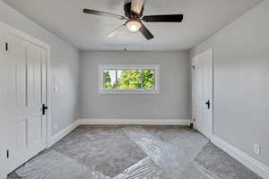 View of second bedroom with two walk in closets.