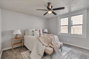 Master Bedroom with light carpet, ceiling fan