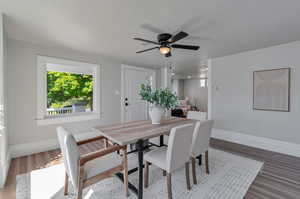 Dining area with front door entrance and view of covered porch.