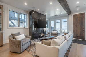 Living room with french doors, light hardwood / wood-style flooring, and plenty of natural light