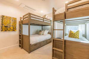 Bedroom featuring light colored carpet