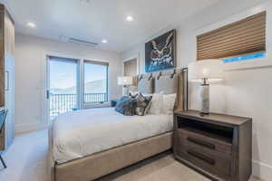 Carpeted bedroom featuring a mountain view and access to outside