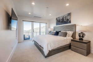 Bedroom featuring access to outside and light carpet