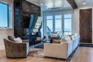 Living room featuring a healthy amount of sunlight, french doors, and hardwood / wood-style flooring