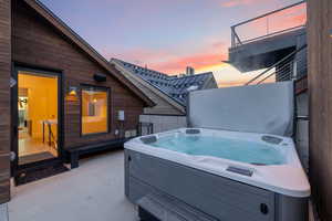 Patio terrace at dusk with a hot tub