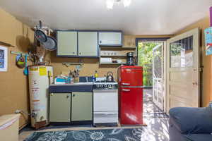 ADU - Kitchen featuring water heater and white range