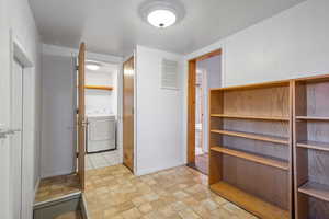 Another view of driveway / mudroom entrance featuring laundryroom