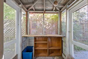 Unfurnished sunroom with wood ceiling and a wealth of natural light