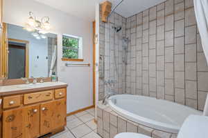 Full bathroom with vanity, shower / bath combo with shower curtain, toilet, and tile patterned floors