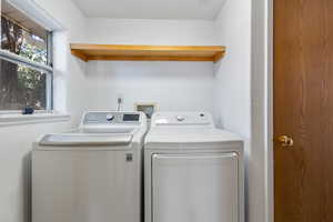 Clothes washing area featuring washing machine and dryer