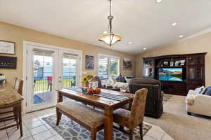 Dining space with vaulted ceiling and light tile patterned flooring