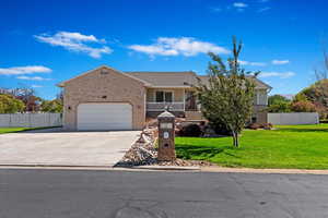 View of front of house with a front lawn and a garage