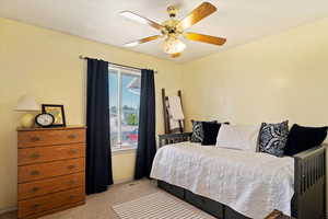 Bedroom with light carpet and ceiling fan