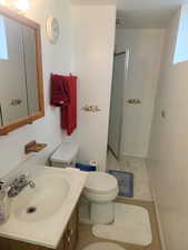 Bathroom with walk in shower, vanity, and toilet