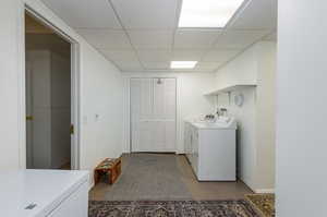 Clothes washing area featuring washing machine and dryer