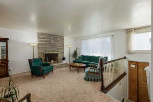 Living room featuring a fireplace and carpet flooring