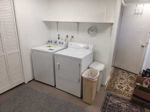 Clothes washing area featuring washing machine and dryer