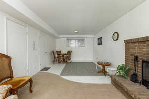 Living area with light carpet and a fireplace